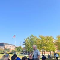 Students reading while professor explains
